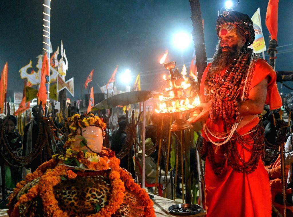 A sadhu performs rituals and offers prayers during Maha Kumbh Mela 2025