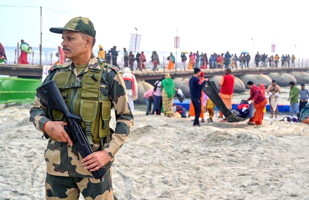 Security personnel stand guard along the banks of the Sangam