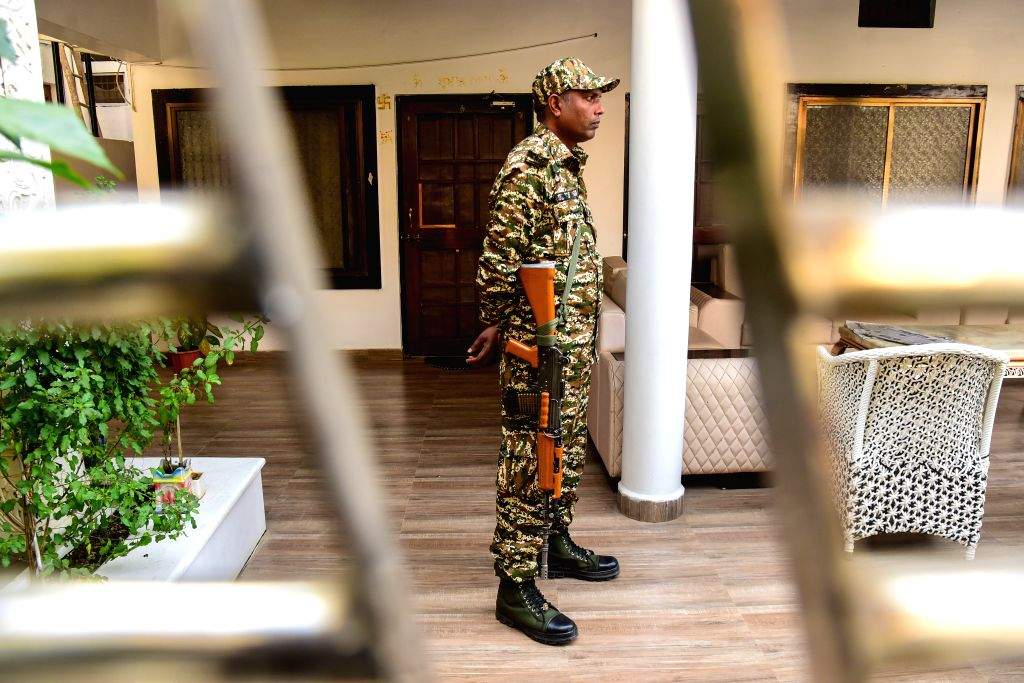 Security personnel stand guard during an Enforcement Directorate (ED ...