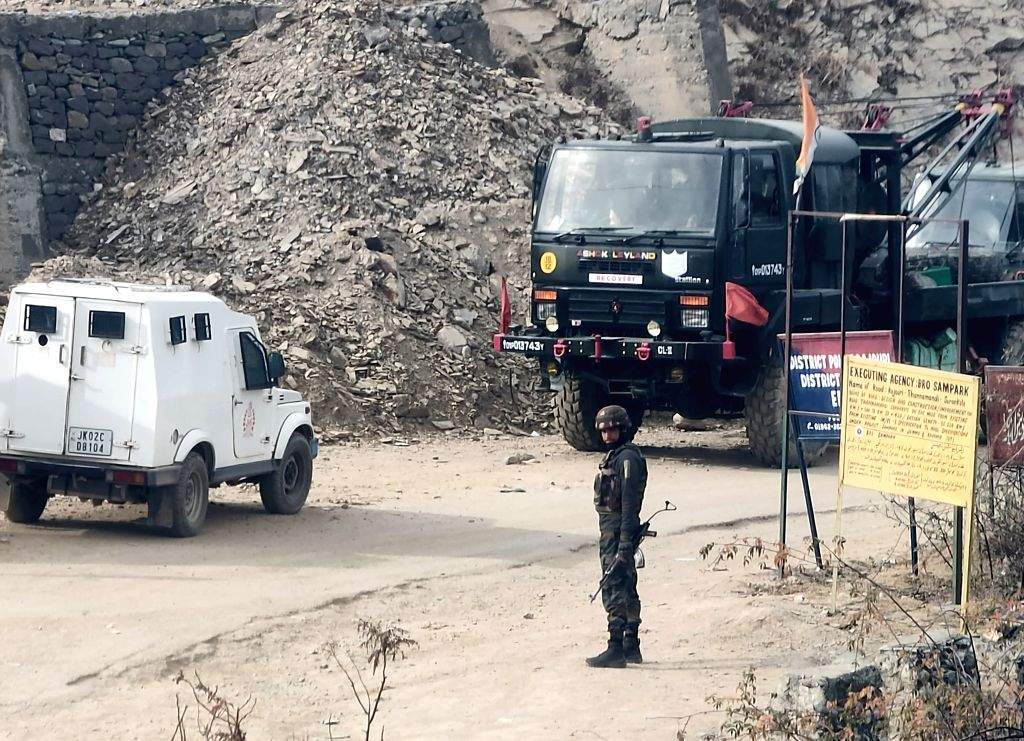 Security personnel stand guard near the site where two Army vehicles ...