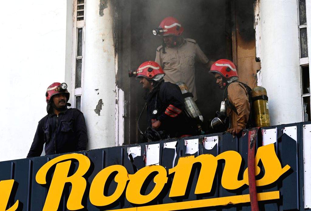 Smoke billows as firefighters try to douse a fire after it breaks out ...