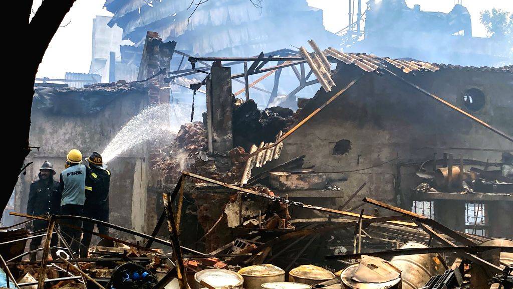 Smoke billows as firefighters try to douse a fire breaks out in a ...