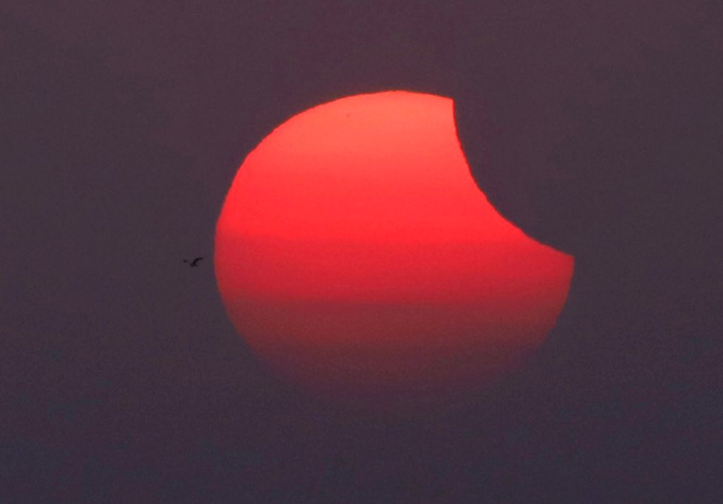 The moon partially covers the sun during the partial solar eclipse