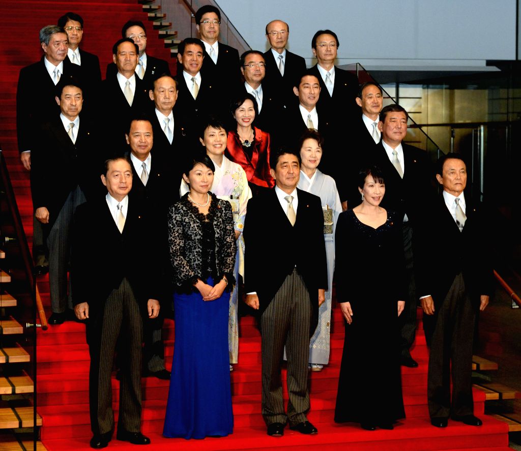 Japan's Prime Minister Shinzo Abe (C, front) and other members of the ...
