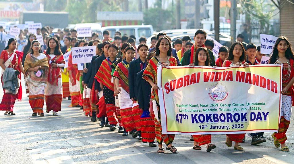 Tribal people walk during a cultural programme celebrating the language ...