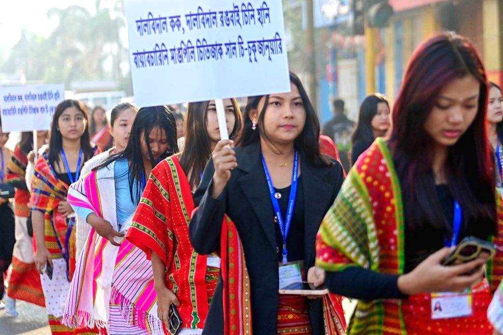 Tribal people walk during a cultural programme celebrating the language ...