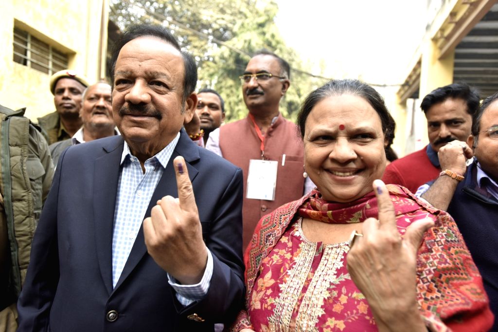 Union Minister Dr. Harsh Vardhan shows his finger marked with indelible ...