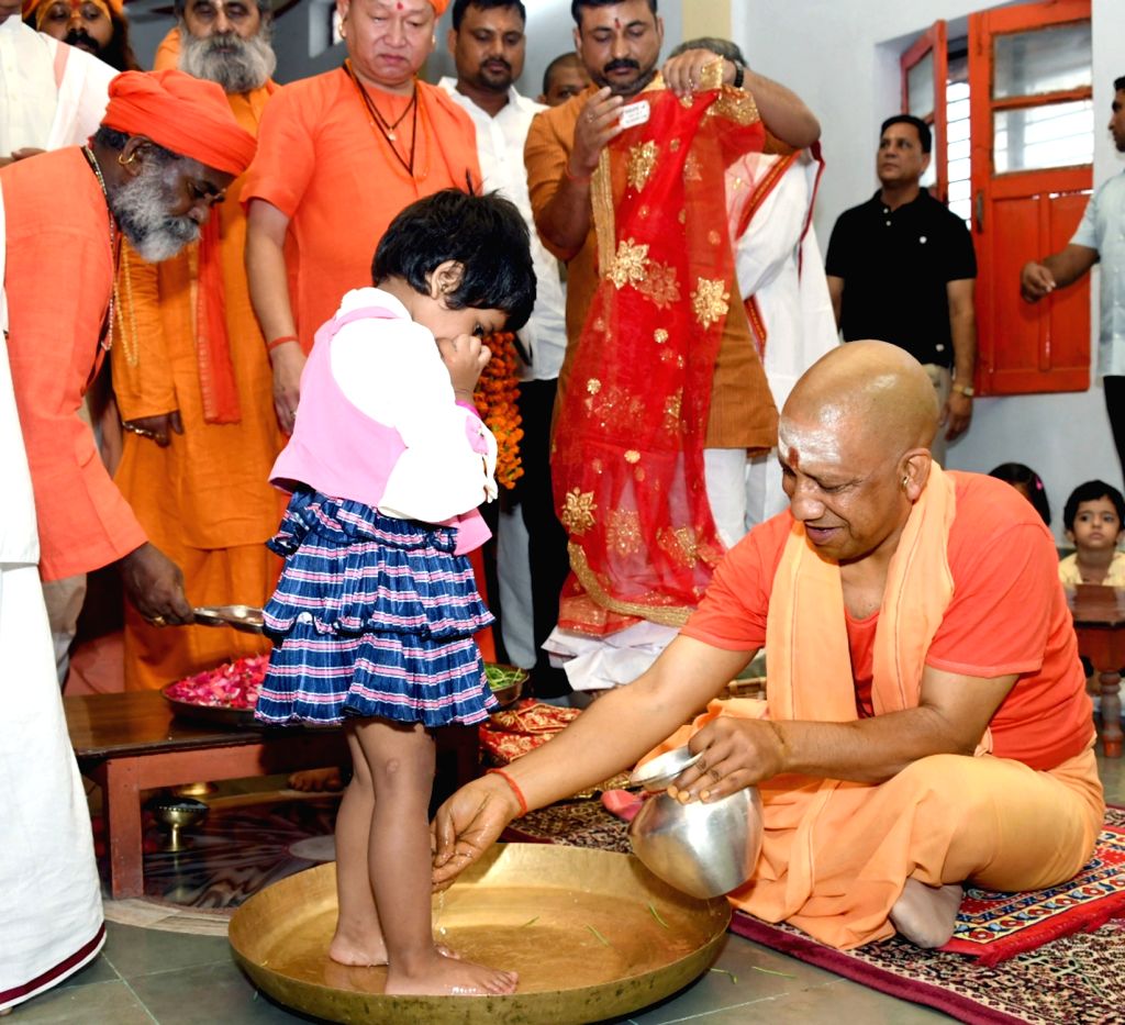 Uttar Pradesh Chief Minister Yogi Adityanath washes feet of a young girl