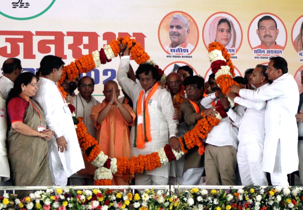 Meerut: Uttar Pradesh Chief Minister Yogi Adityanath being garlanded ...