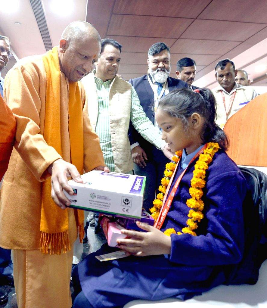 Uttar Pradesh Chief Minister Yogi Adityanath felicitates a person with ...