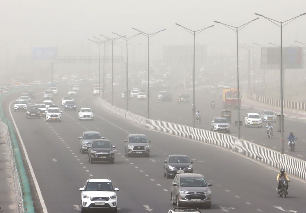 Vehicles ply on the road as the air quality deteriorates due to dust ...