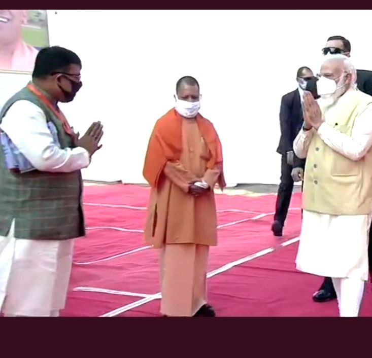 Free Photo: Yogi Adityanath greets PM Modi on his visit to Varanasi