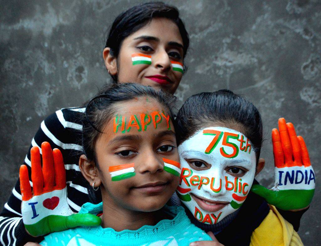 Young women with their face and hands painted in the Indian tricolours ...