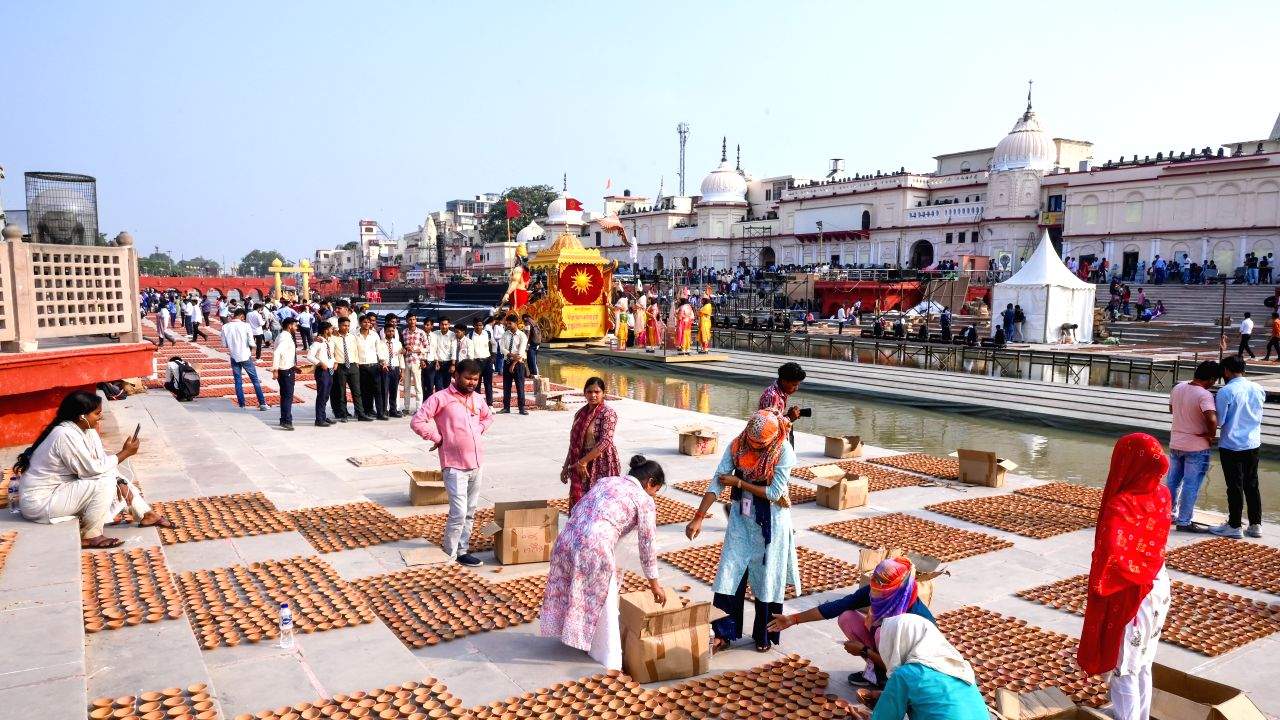 People prepare for the Deepotsav festival by arranging diyas ahead of Diwali in Ayodhya 