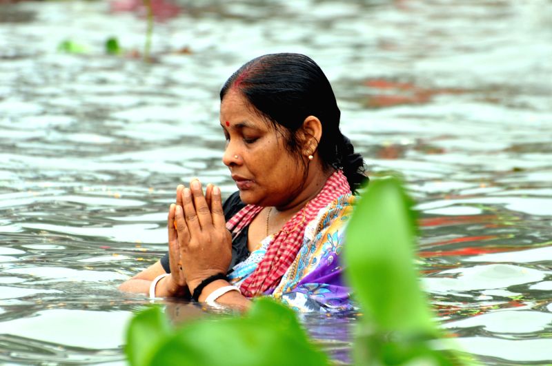 Bangladeshi Hindu devotees take a holy bath during Astami Snan ...
