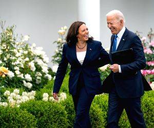 Joe Biden talks with Kamala Harris in the White House garden