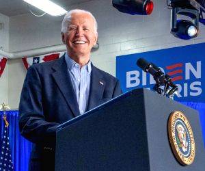 President of the United States Joe Biden gestures to the crowd as he delivers remarks at a campaign rally at Sherman Middle School